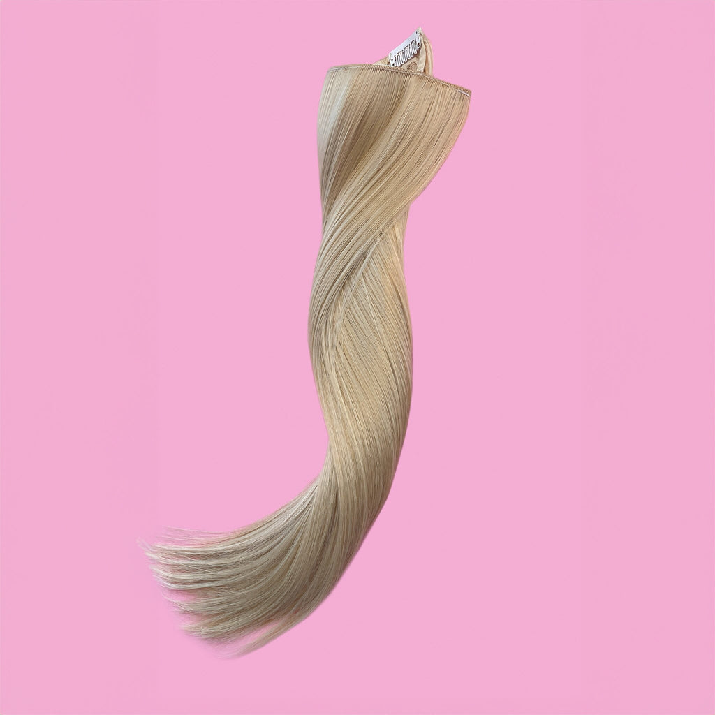 Big Glam Nation 21 inch beige blonde extensions laid out against pink background. (Blonde Extensions; Blonde Clip Ins).