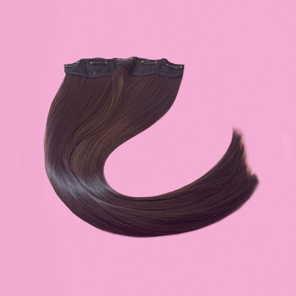 Big Glam Nation 21 inch deep maroon extensions laid out against pink background.