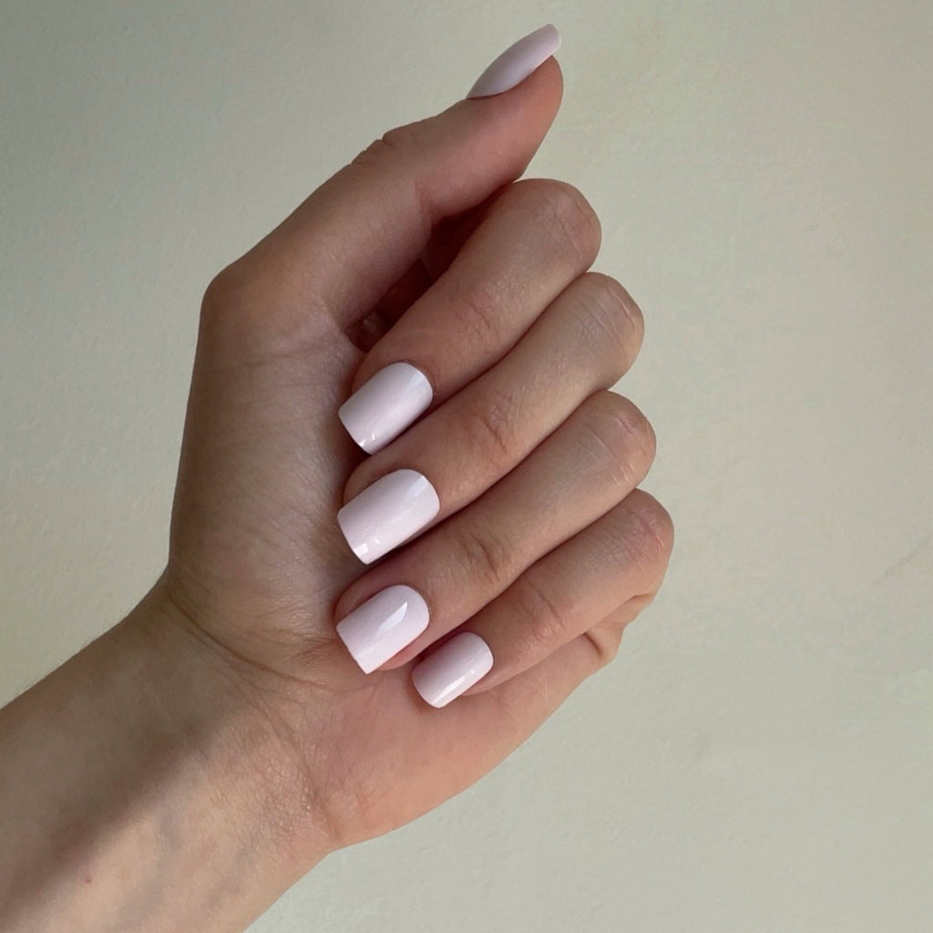 Short Press On Nails in BGN's Soft Pinks worn against neutral background by fair-skinned model.