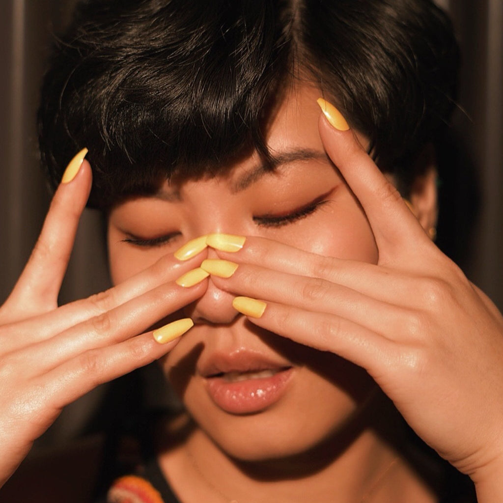 Press on nails in Big Glam Nation's Honeycombs worn by beautiful olive skinned model in facial/portrait shot.