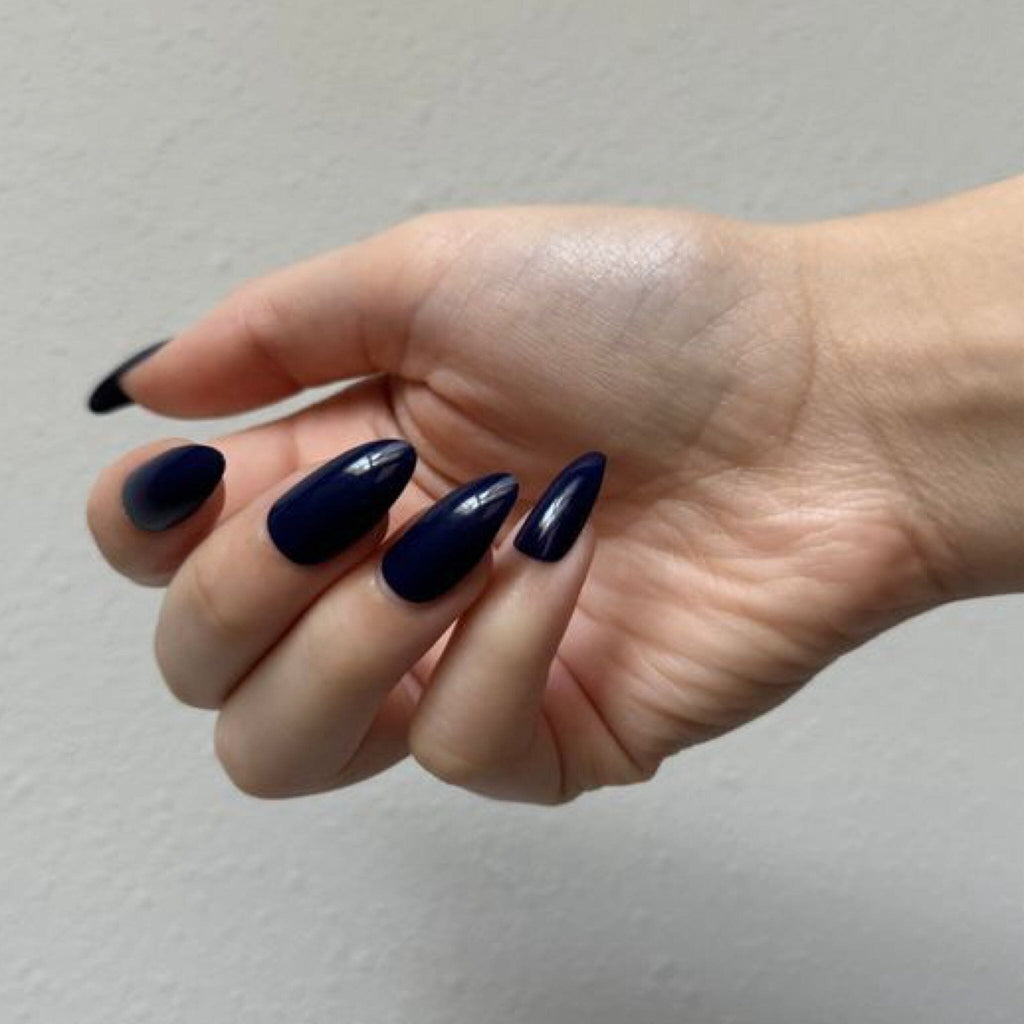 Press On Nails in BGN's Blue Solids worn by fair-skinned model against white background.