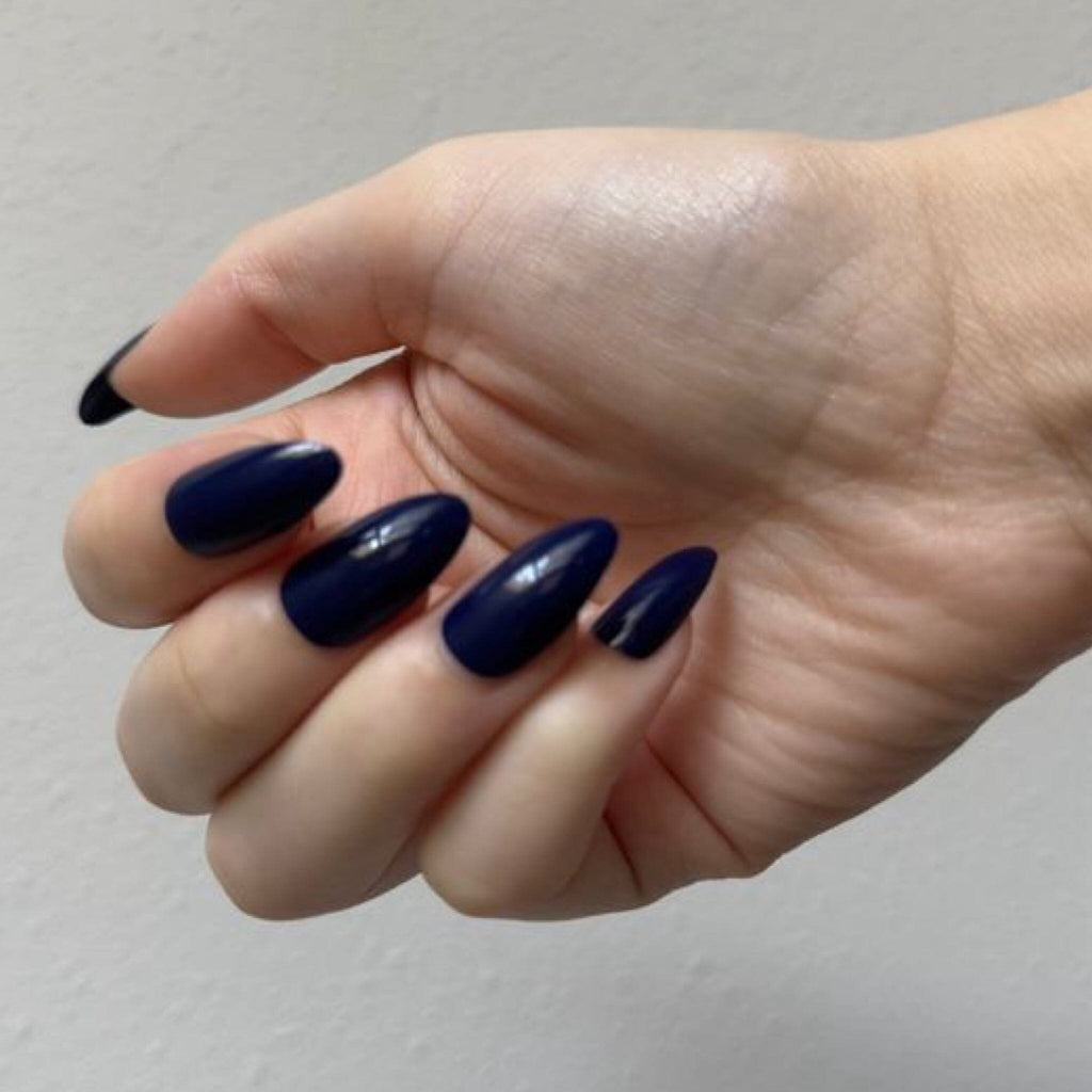 Press On Nails in BGN's Blue Solids worn by fair-skinned model against white background.