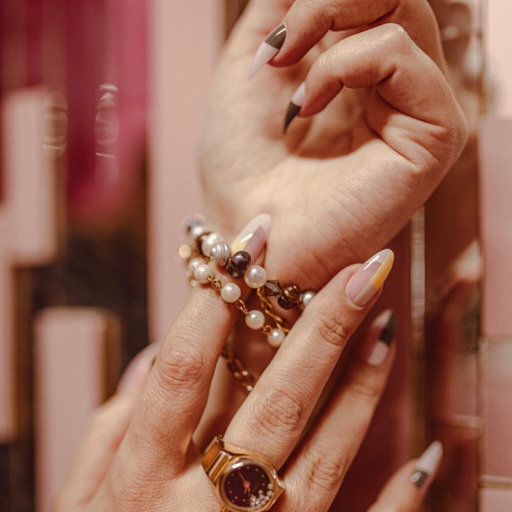 Press on Nails in Big Glam Nation's Pink Architects work by fair-skinned model against mirror background.