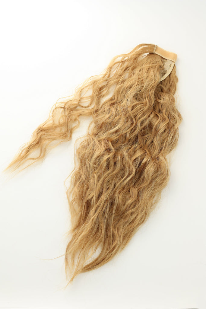 Hair Extensions in Big Glam Nation's Sandy Blonde highlight thickness perfect for thin hair while laid on white background.