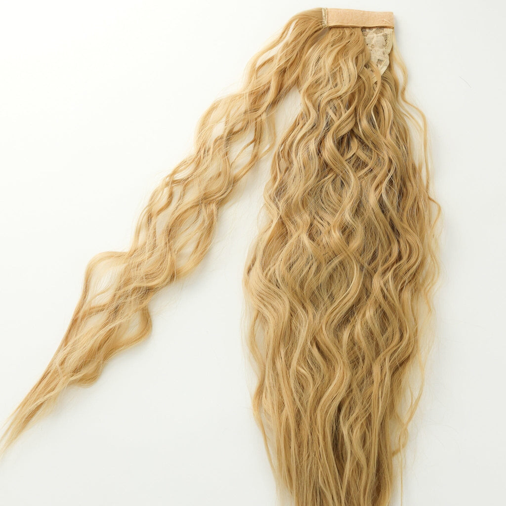 Wavy Hair Extensions in BGN's Sandy Blonde laid flat against white background.