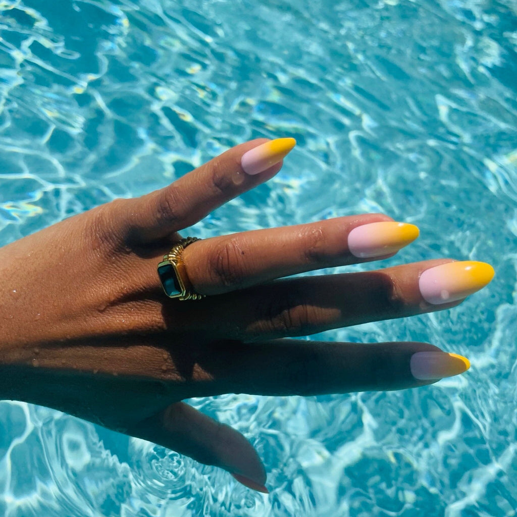 Press On Acrylic Nails in Big Glam Nation's Little Mandarins worn by brown-skinned model.