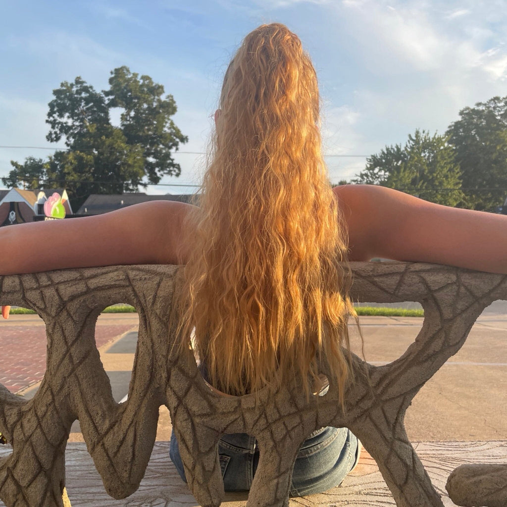 Ponytail Extensions in Big Glam Nation's Sandy Brown shows wavy texture and bright color. Rich color glows in the sunlight.