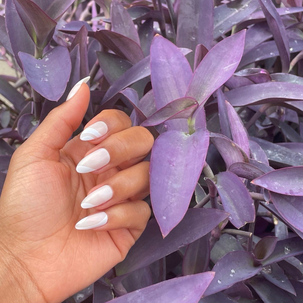 Brown-skinned model wears Big Glam Nation's press-on acrylic nails in White Icing.