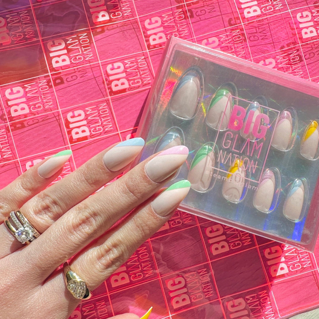 Press On Nails in Big Glam Nation's Soft Multicolor  against BGN packaging on fair-skinned model.