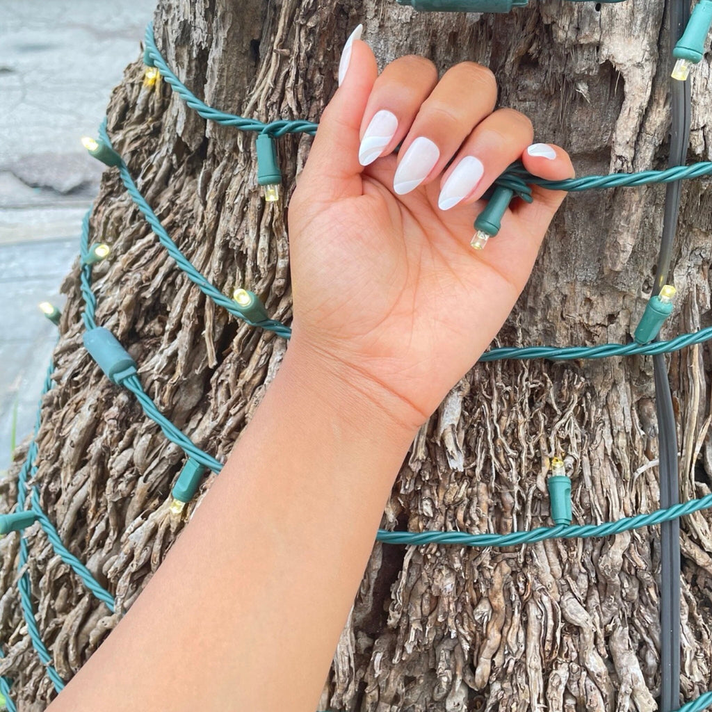 Brown-skinned model wears Big Glam Nation's White Icing press on nails.