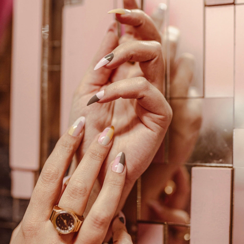 Press on Nails in Big Glam Nation's Pink Architects work by fair-skinned model against mirror background.