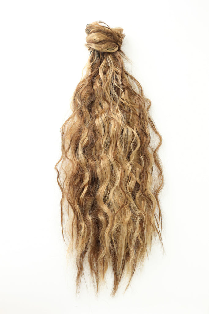 The Big Glam Nation crimped ponytail is laid flat on an off-white background. The ponytail has a wavy texture, in a blended color of varied shades of brown, with a velcro wraparound application.