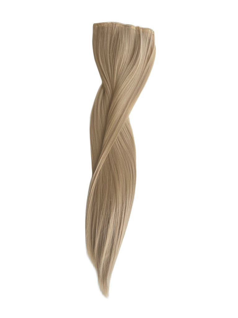 Big Glam Nation 21 inch extensions in soft and wispy ash laid against white background.