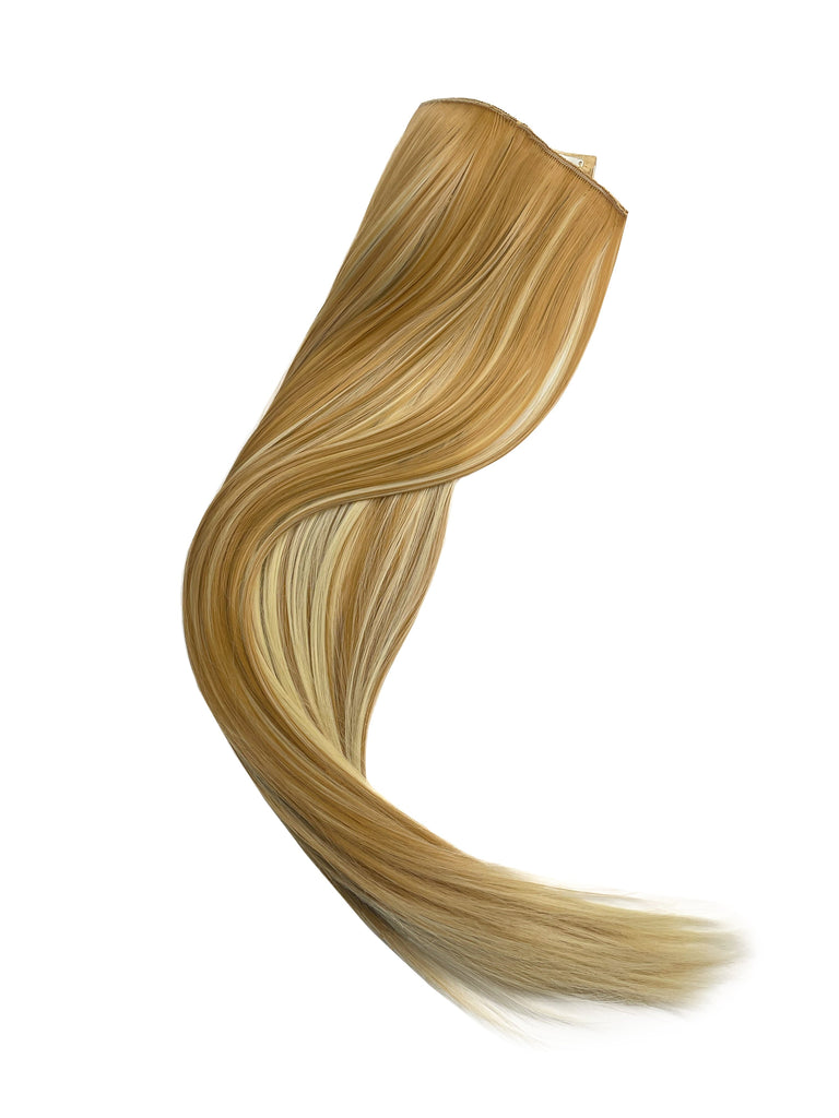 Big Glam Nation 21 inch bleached blonde on sandy brown extensions laid against white background.