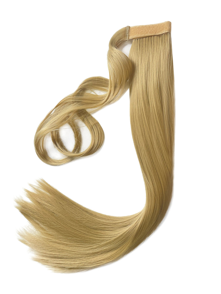 The Big Glam Nation Sleek Ponytail is laid flat against a white background in the color Beach Sand Blonde. Length and shine of the extensions are highlighted.