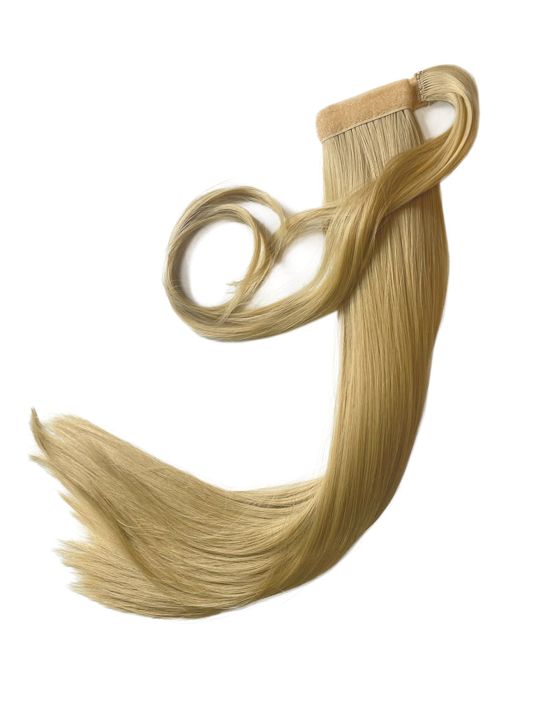 The Big Glam Nation Sleek Ponytail is laid flat against a white background in the color Beach Sand Blonde. Length and shine of the extensions are highlighted.