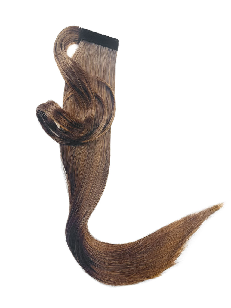 The Big Glam Nation Sleek Ponytail is laid flat against a white background in the color Black on Brown. Length and shine of the extensions are highlighted.